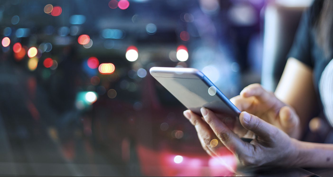 Woman using mobile smart phone in the night light colorful background "Person texting on their smartphone, navigating online dating, relationship communication, and modern romance through messaging apps."