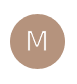 Brown circle with letter "M" on black.